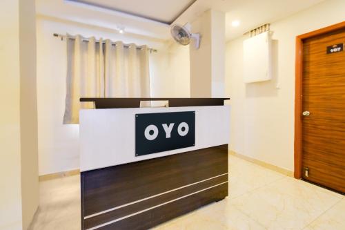 a reception desk with a sign on it in a room at Hotel O Skyline in Surūrnagar
