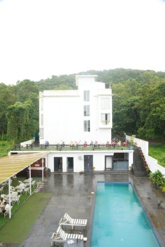 a view of a building with a swimming pool at Baga Courtyard in Anjuna