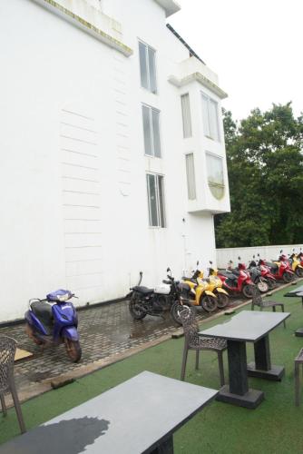 a group of motorcycles parked next to a building at Baga Courtyard in Anjuna