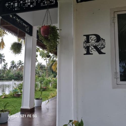 a front door of a house with a sign on it at Riverview villa in Alleppey