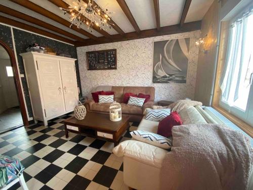 a living room with a couch and a table at Perle de sel, centre du Crotoy, 8 pers in Le Crotoy