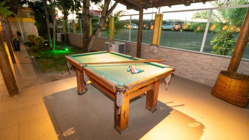 a pool table sitting on top of a floor at Pousada Itajuípe- Unidade Itabuna-Ba in Itabuna