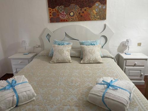 a bedroom with a large bed with two night stands at Apartment in Porto Cervo surrounded by greenery in Abbiadori