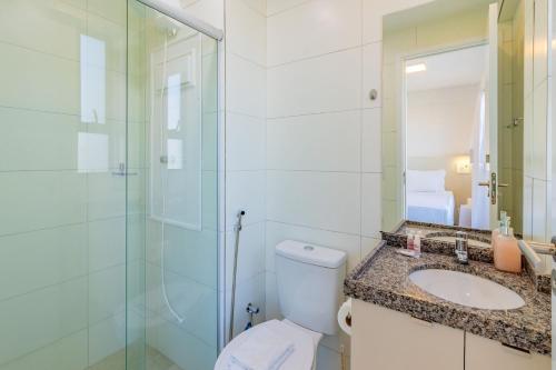 a bathroom with a toilet and a shower and a sink at Allure Residence by Carpediem in Recife