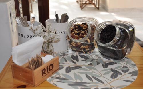 a table with two jars of food on a table at RIO TIGRE HOTEL in Tigre