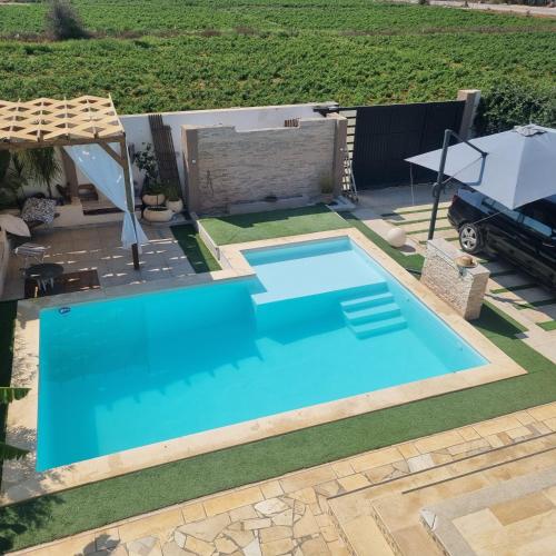 a swimming pool in a yard with a table at DAR-Layem in Hanshīr Qaşr Ghallāb
