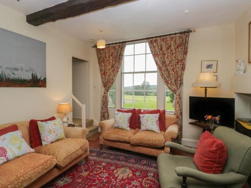 a living room with two couches and a large window at The Old Kitchen in Grange Over Sands