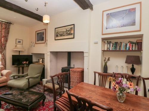 a living room with a table and a fireplace at The Old Kitchen in Grange Over Sands