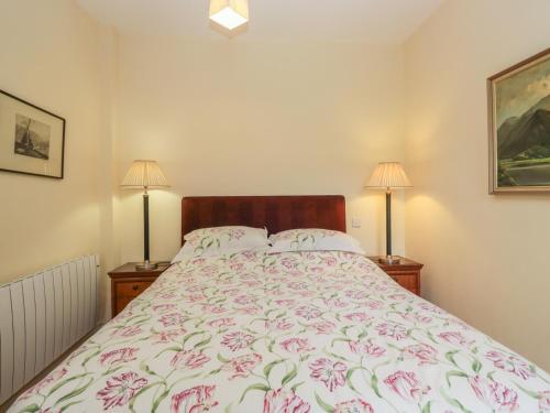a bedroom with a bed and two lamps at The Old Kitchen in Grange Over Sands