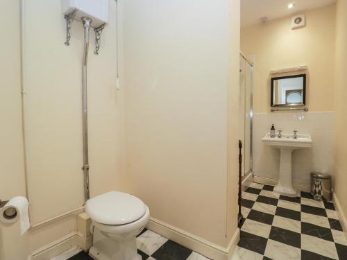a bathroom with a toilet and a sink at The Old Kitchen in Grange Over Sands