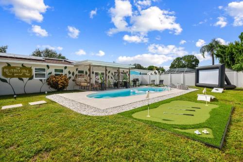 a house with a swimming pool and a yard at The Beverley Pool Hot Tub Near Clearwater Beach in Clearwater