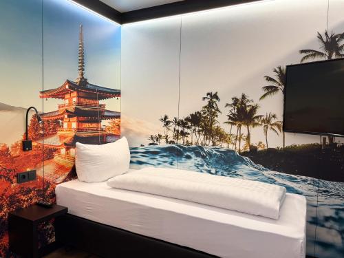 a room with a bed with a view of a tower at ENA Hotel by WMM Hotels in Krauthausen