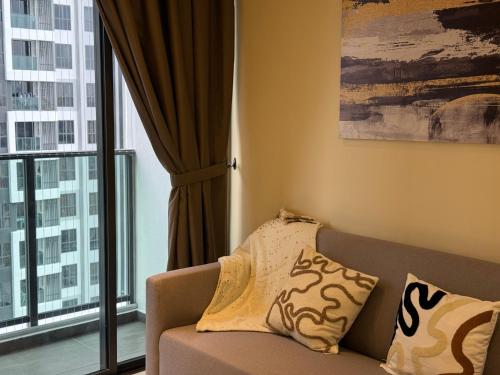 a living room with a couch and a large window at Shelisa's Modern 3BR House at Suria Garden Puchong in Puchong