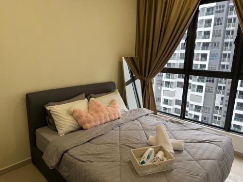 a bedroom with a bed with pillows and a window at Shelisa's Modern 3BR House at Suria Garden Puchong in Puchong