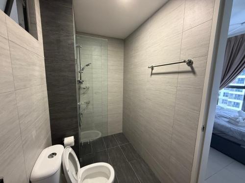 a bathroom with a toilet and a shower at Shelisa's Modern 3BR House at Suria Garden Puchong in Puchong