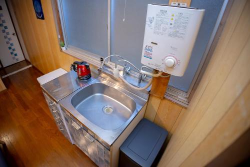 ein Badezimmer mit Waschbecken in einem Zimmer in der Unterkunft Voyager Inn in Tokio