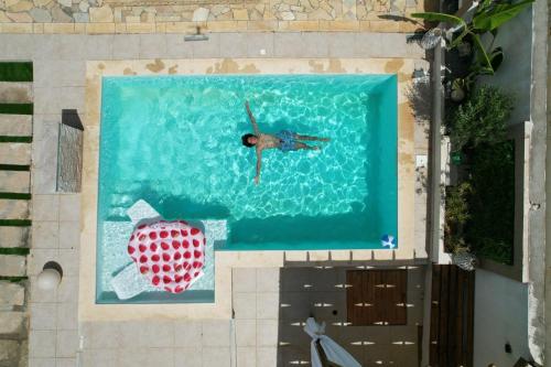 a person swimming in a swimming pool with a heart at DAR-Layem in Hanshīr Qaşr Ghallāb