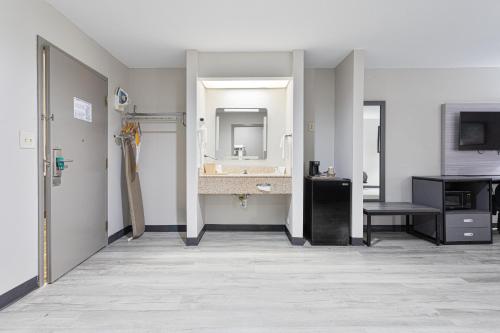 a bathroom with a sink and a mirror at Quality Inn Edmund Pettus Bridge area in Selma