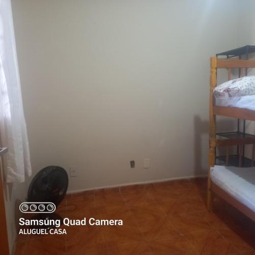 a bedroom with two bunk beds and a wooden floor at Alojamento para Empreiteira in Sumaré