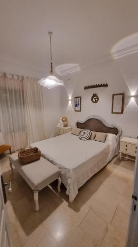 a bedroom with a large bed and a chair at DAR-Layem in Hanshīr Qaşr Ghallāb