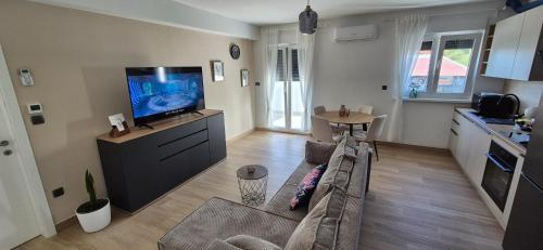 a living room with a couch and a flat screen tv at Marin&Mark Stay in Zagreb