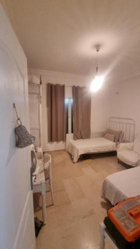 a living room with two beds and a couch at DAR-Layem in Hanshīr Qaşr Ghallāb