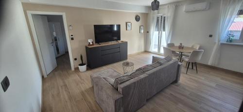 a living room with a couch and a flat screen tv at Marin&Mark Stay in Zagreb