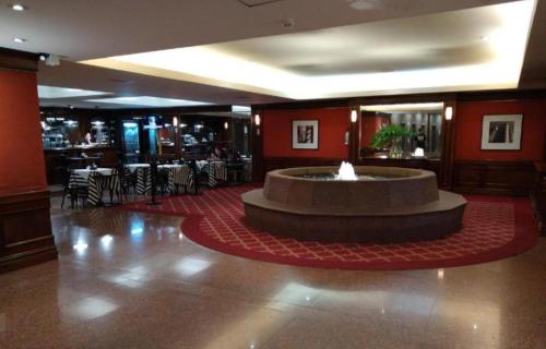 a lobby with a fountain in the middle of a room at Tango BA 2 in Buenos Aires