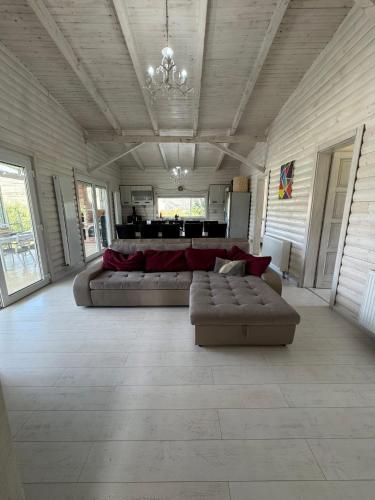 a large living room with a couch and a table at Cabana Zouk in Poiana Aiudului
