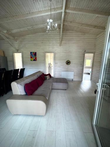 a living room with a white couch in a room at Cabana Zouk in Poiana Aiudului