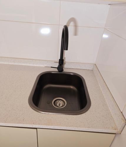 a kitchen sink with a faucet on a counter at Sandown Suites and Conference Centre in Johannesburg