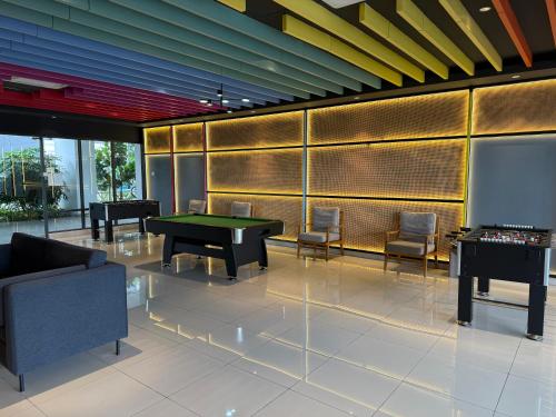 a lobby with a pool table and a piano at Shelisa's Modern 3BR House at Suria Garden Puchong in Puchong