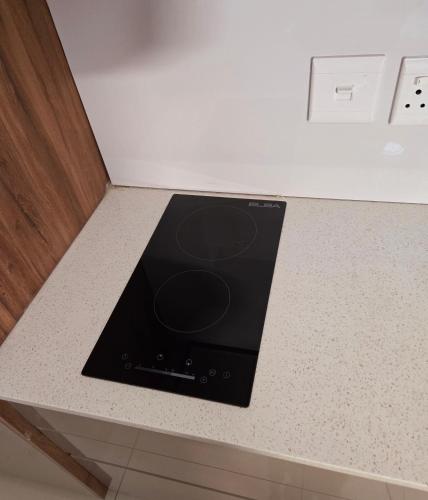 a stove top oven sitting on top of a counter at Sandown Suites and Conference Centre in Johannesburg