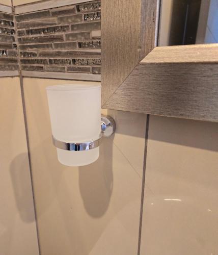 a candle on the wall of a bathroom at Sandown Suites and Conference Centre in Johannesburg