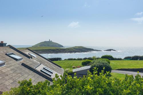 a house with a view of the ocean at Salty Dog Restaurant, Pub & Guesthouse in Ballycotton