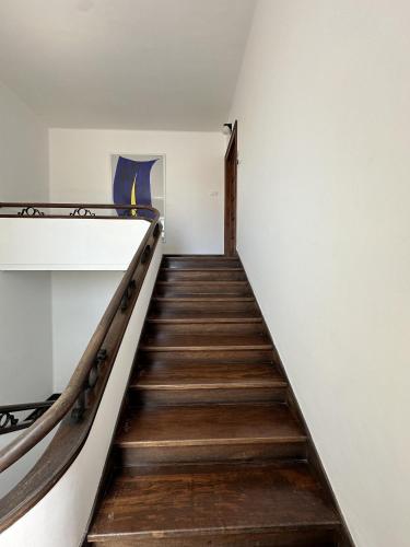 a stairway in a building with wooden stairs at Apartament 6 - By WeHost in Funchal