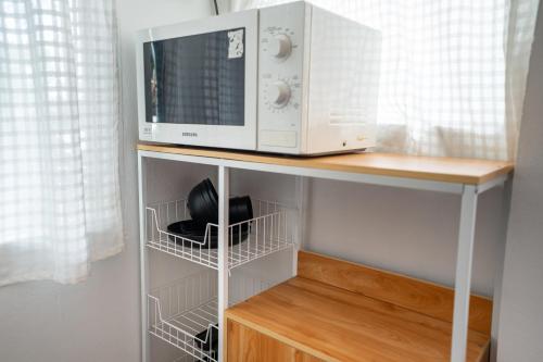 a microwave oven sitting on top of a shelf at 640 Villa in Ko Lanta
