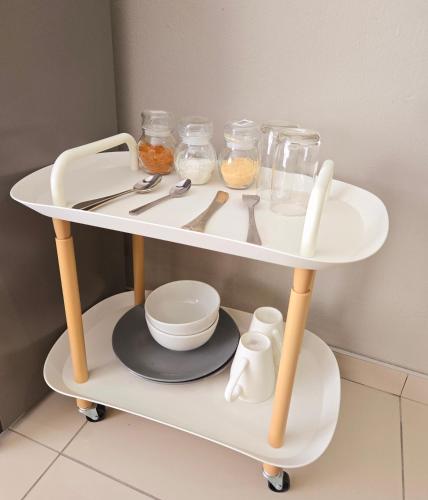 a white shelf with utensils on it in a kitchen at Sandown Suites and Conference Centre in Johannesburg