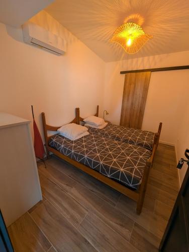 a bedroom with a bed and a light on the ceiling at Stay Padel House in Perpignan