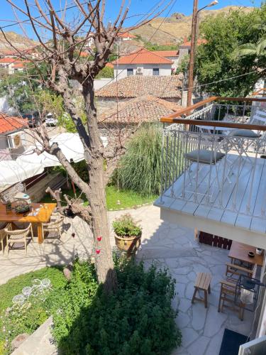 a tree in the yard of a house at Aelia Apartments Limnos in Thános