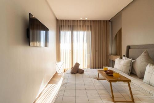 a living room with a couch and a table at Appartement Anfa Park casa finance City CFC in Casablanca