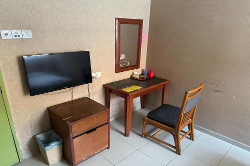 Una televisión o centro de entretenimiento en ANGSA Hotel