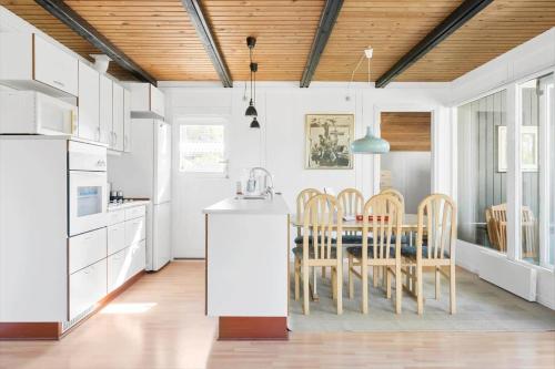 a kitchen and dining room with a table and chairs at 30718-Odder-Alrovej-145 in Odder
