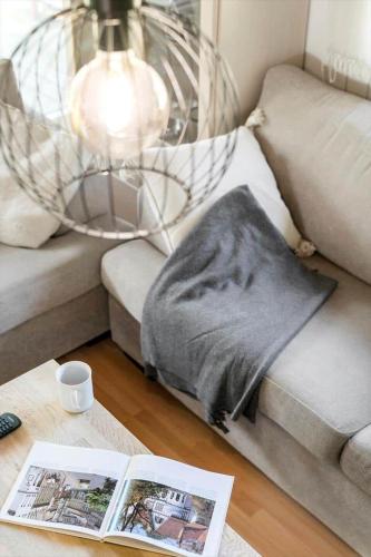 a living room with a couch with a blanket on a table at 30718-Odder-Alrovej-145 in Odder