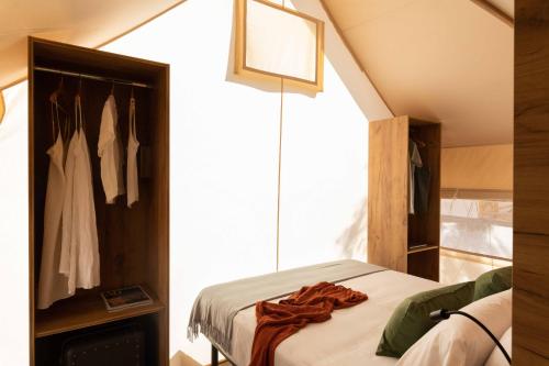 a bedroom with a bed and a closet at Wecamp San Sebastián in San Sebastián
