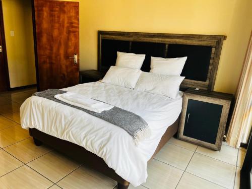 Ένα ή περισσότερα κρεβάτια σε δωμάτιο στο Blue Hazel Guest House