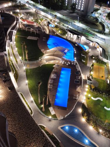 a night view of a swimming pool at night at Sunset Waves Benidorm by KalmaRent in Benidorm