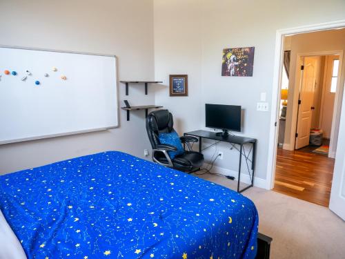 a bedroom with a bed and a desk and a screen at New! Fair Winds Private Island Oases w Heated Pool & more! in Merritt Island
