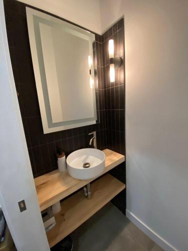 a bathroom with a white sink and a mirror at Lakefront-Spa-Luxury in true nature! in La Minerve