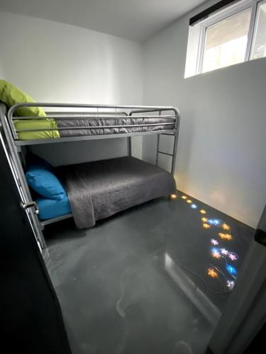 an empty bunk bed in a room with a window at Lakefront-Spa-Luxury in true nature! in La Minerve